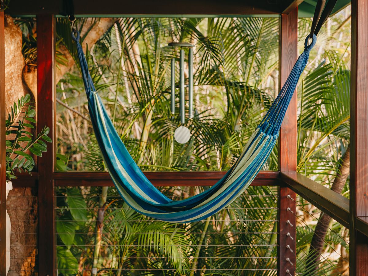 Blue hammock on the covered deck at Moon Cottage overlooking the jungle