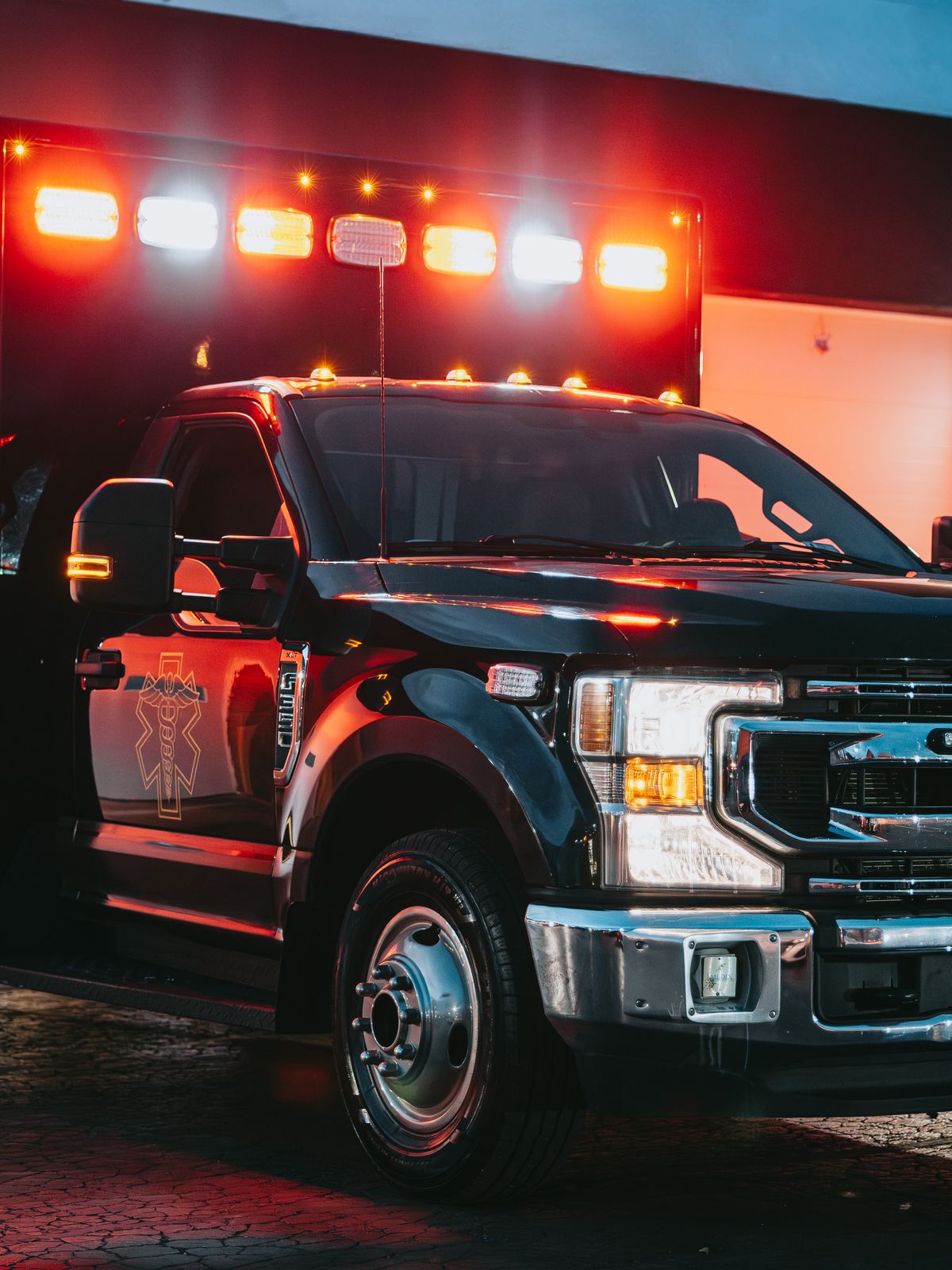 Northwest Rescue ambulance with emergency lights on at dusk, filmed by Identity Start