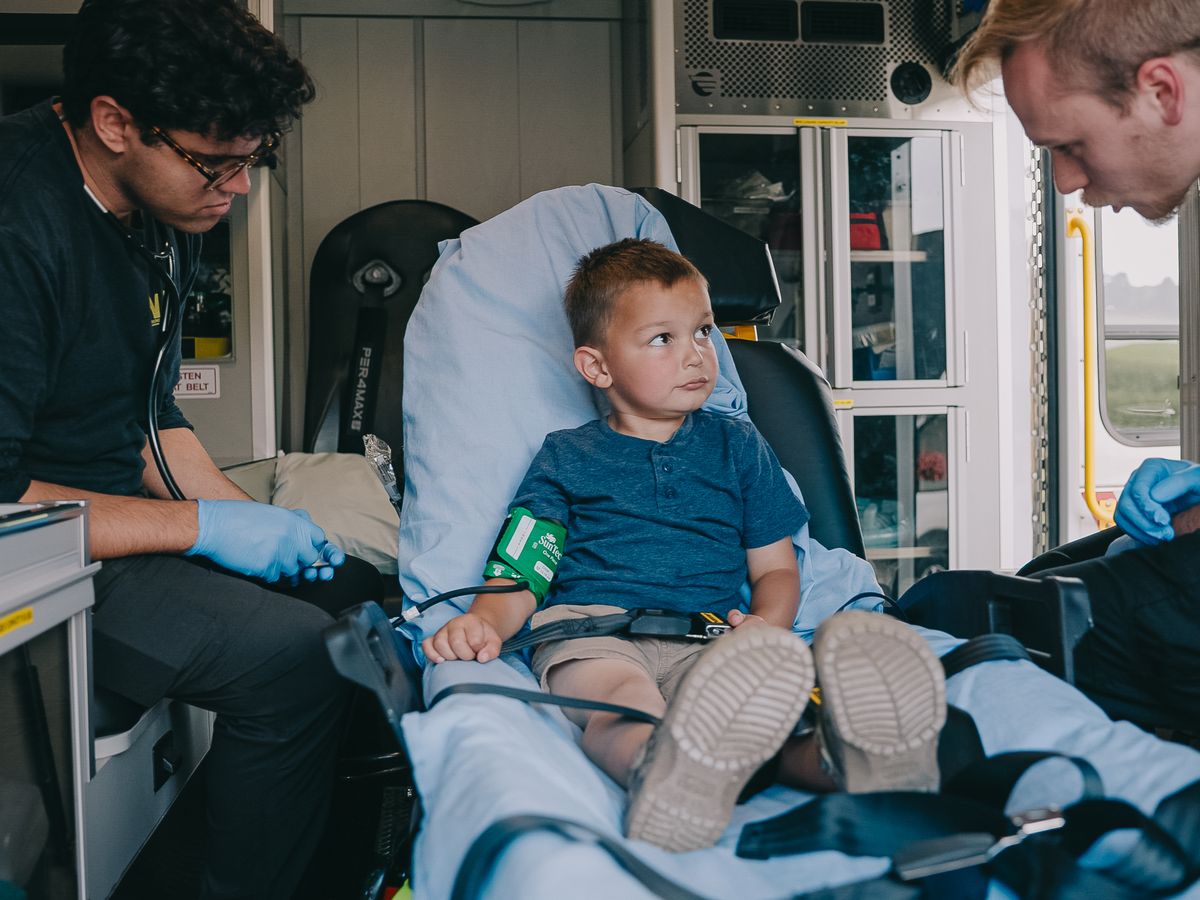Northwest Rescue crew caring for a young pediatric patient inside the ambulance