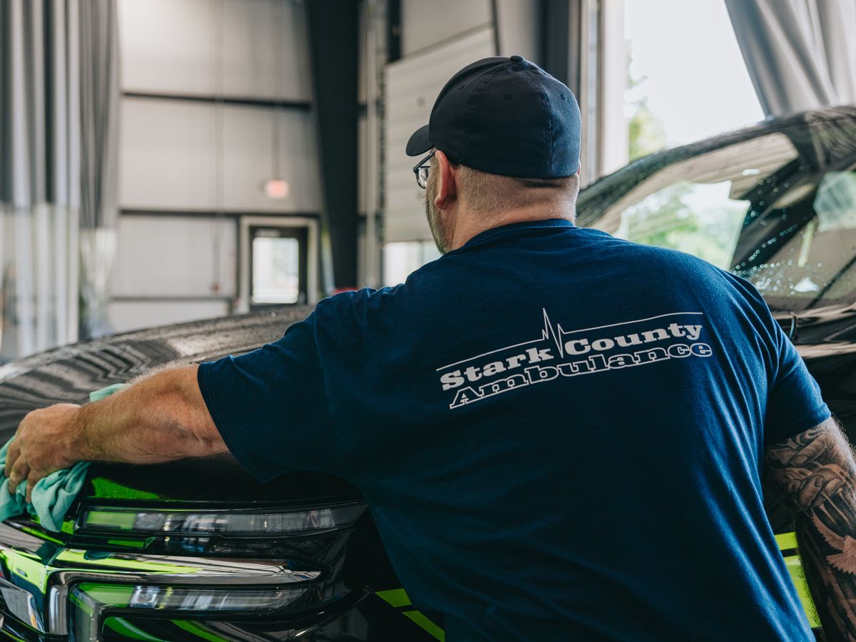 Stark County Ambulance crew member detailing a response vehicle in the station