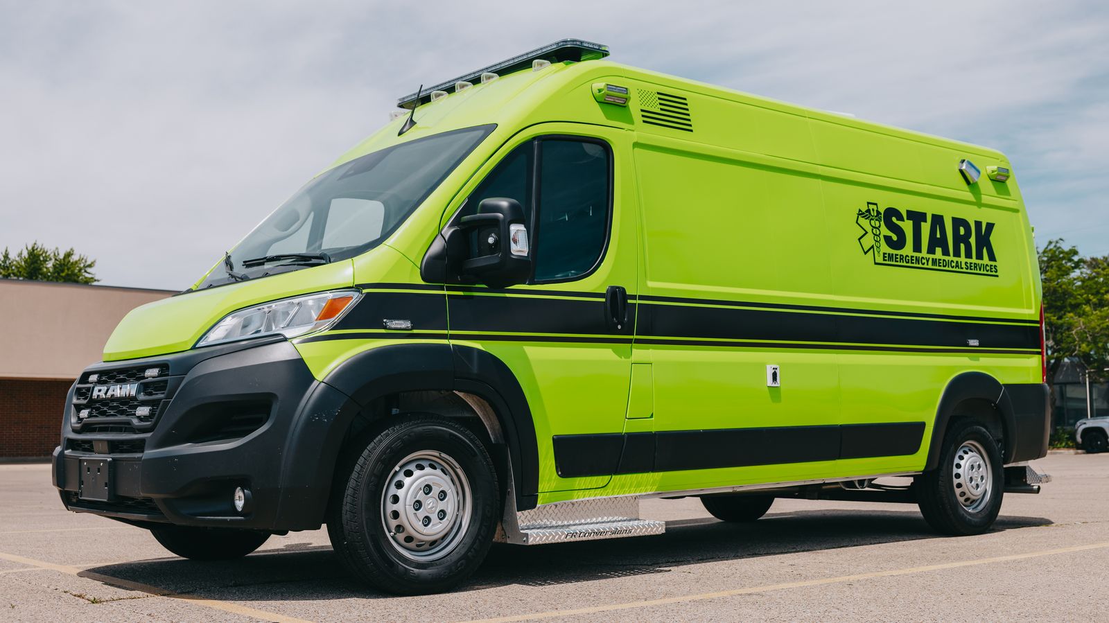 Lime green Stark County Ambulance parked outside the station