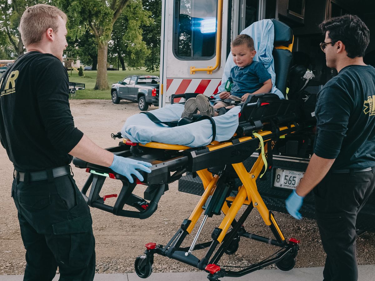 Northwest Rescue crew preparing a patient on a stretcher outside the ambulance