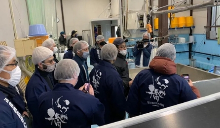 Visitors touring a sake brewery and learning about the brewing process
