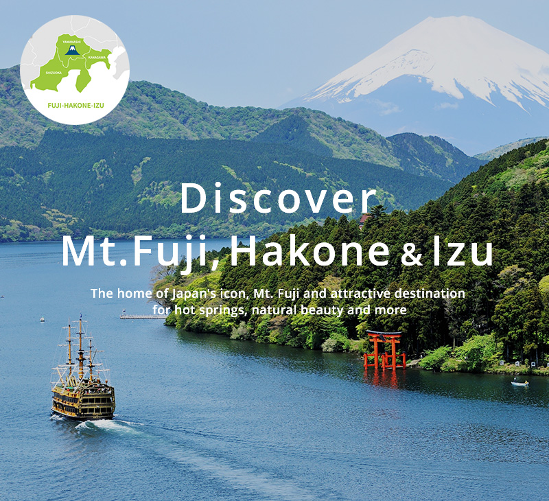 Mount Fuji viewed across a lake framed by vibrant autumn maple leaves in the Fuji-Hakone-Izu region