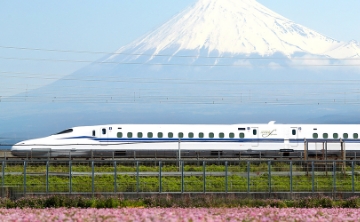 A sleek Shinkansen bullet train glides past Mount Fuji, blending modern innovation with Japan’s timeless natural beauty.