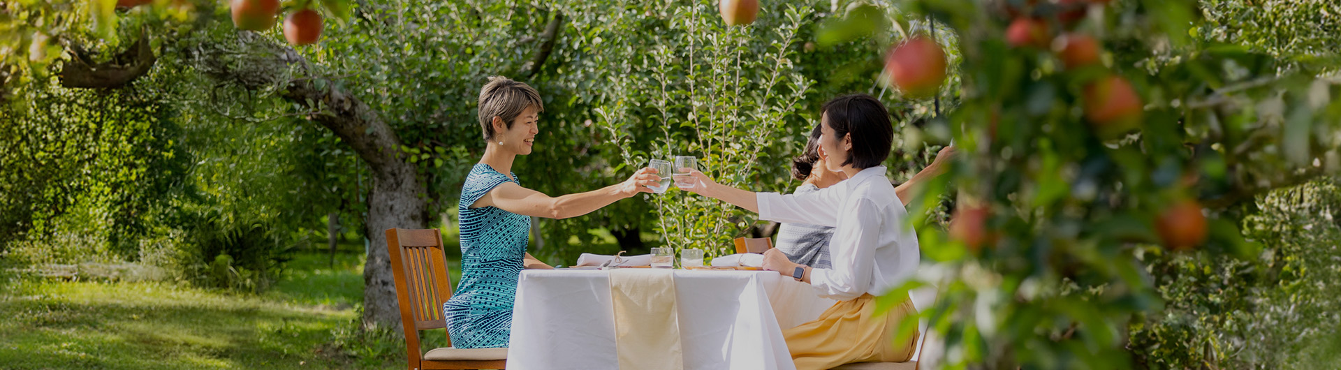 Group of friends enjoying a traditional Japanese meal together, raising their glasses in a cheerful toast
