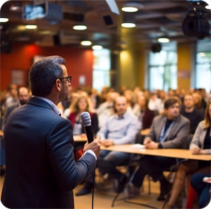 Four business professionals in formal attire sitting around a conference table during a meeting.