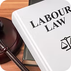 Book titled 'Labour Law' next to a wooden judge's gavel on a desk.