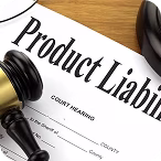 Gavel resting on a court document titled 'Product Liability' on a wooden surface.