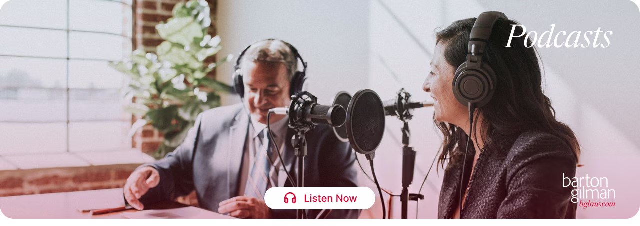 Two people wearing headphones speaking into microphones in a bright studio for a podcast recording.