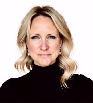 Smiling woman with long dark hair wearing a black blazer and pearl necklace on a white background.