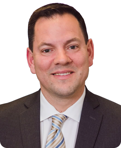 Portrait of a man in a dark suit, light shirt, and striped tie smiling against a white background.