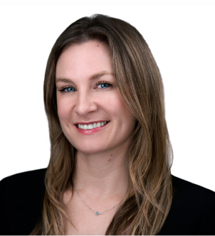 Smiling woman with long light brown hair wearing a black blazer and black top against a white background.