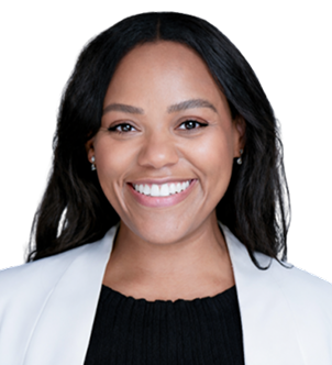 Smiling woman with long black hair wearing a white blazer and black top.
