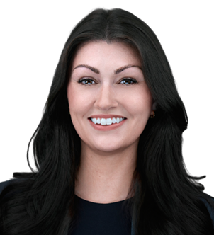 Smiling woman with long brown hair wearing a dark top against a dark background.