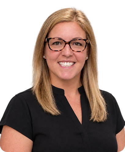 Smiling woman with shoulder-length blonde hair wearing tortoiseshell glasses and a green floral blouse.