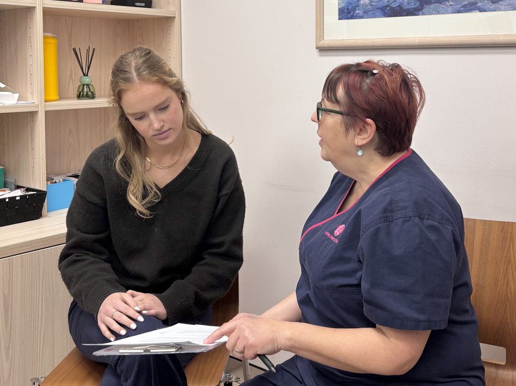 young woman in clinical consultation at sydney breast clinic with nurse