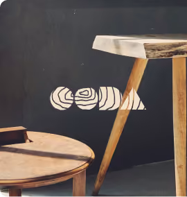 Furniture brand identity displayed beside wooden chairs and a table.