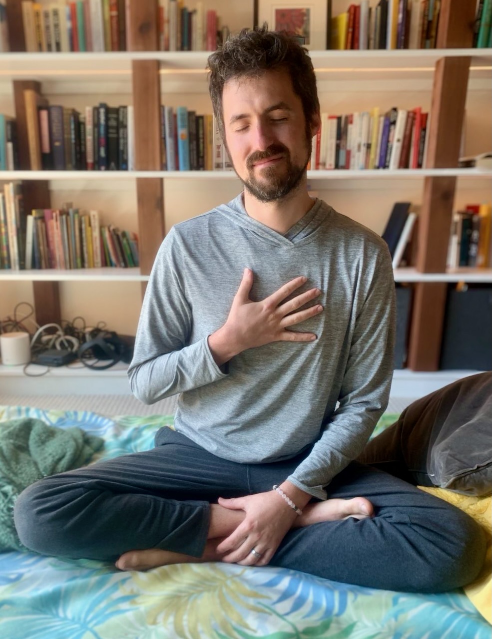 Ben with hand on his heart during meditation