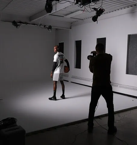 Behind-the-scenes view of a Media&Motion commercial photoshoot in a Calgary studio, with photographer capturing an athlete during campaign production.