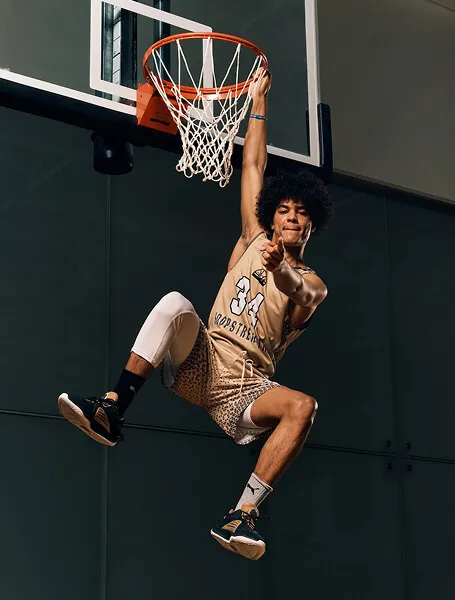 Calgary youth basketball player performing a dunk during a HoopStrength Media Day action shoot captured by Media&Motion.