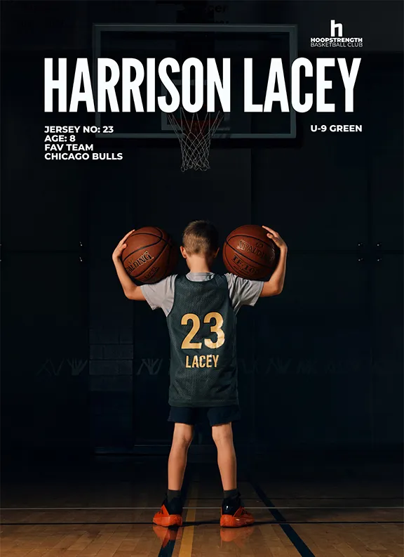 Young boy basketball player Harrison Lacey wearing jersey number 23 holds two basketballs, standing on a court facing a hoop.