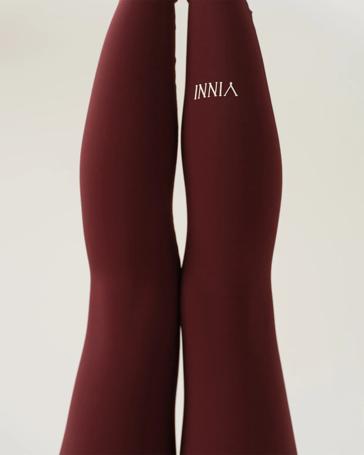 Calgary fashion studio photo for Vinni The Label by Media&Motion - minimalist yoga-inspired campaign showcasing maroon athletic leggings and refined lifestyle design.