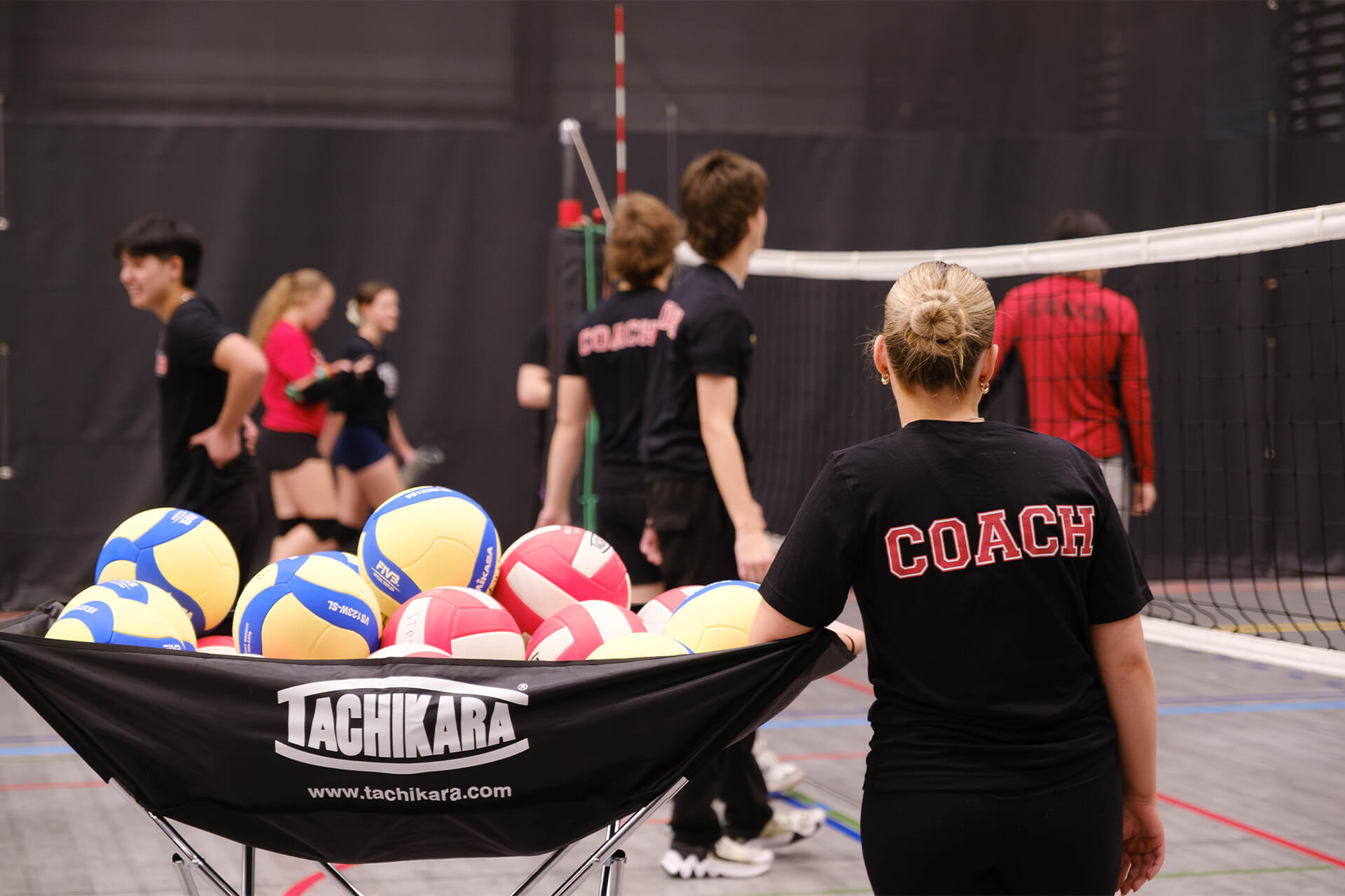 Youth volleyball coach leading training session during Stryker Sports community program in Calgary.