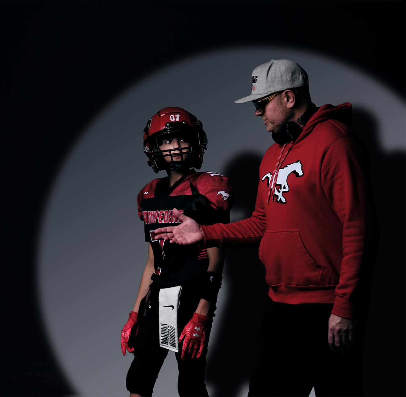 Youth football athlete in guided studio session with coach during The Making Years creative project in Calgary.
