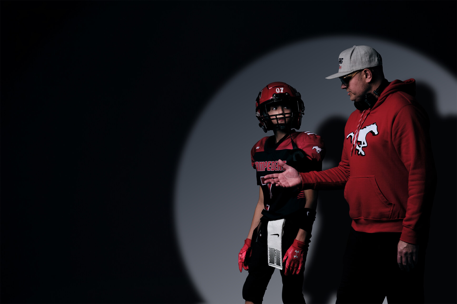 Youth football athlete in guided studio session with coach during The Making Years creative project in Calgary.