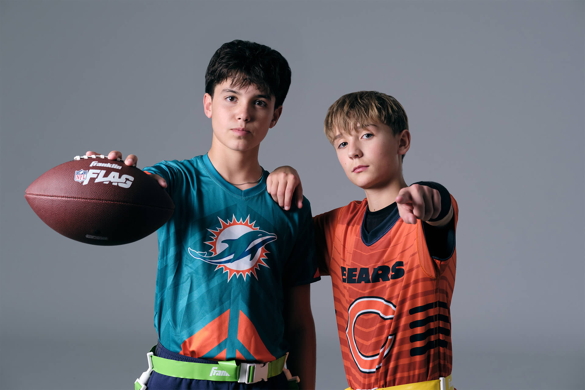 Studio football portrait showcasing teamwork and early athlete identity formation.