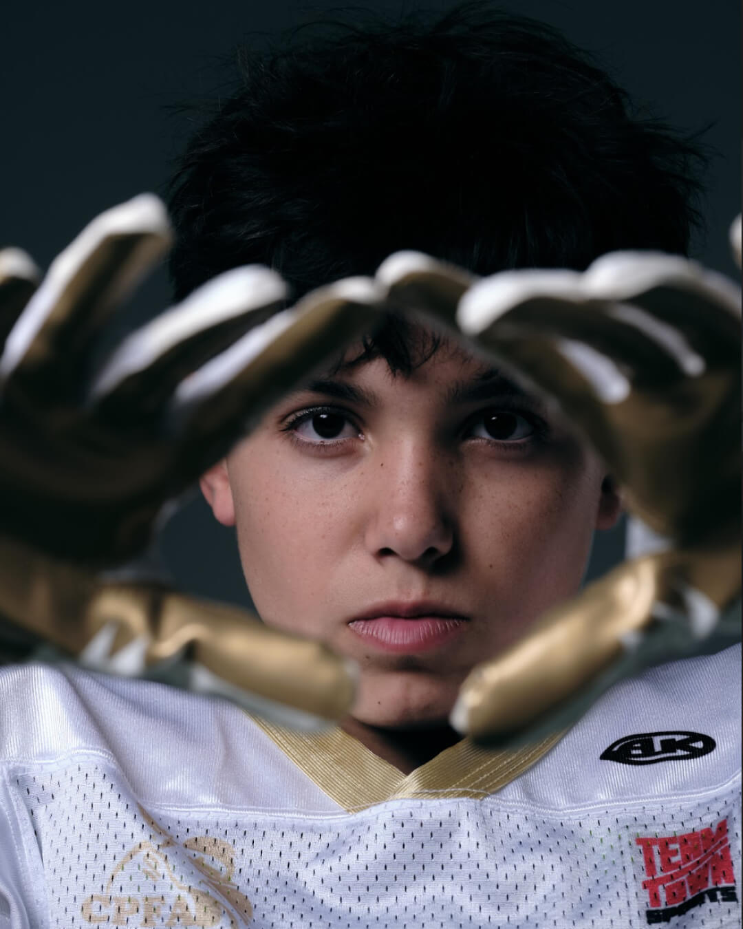 Cinematic youth football portrait focusing on athlete presence and self-belief.