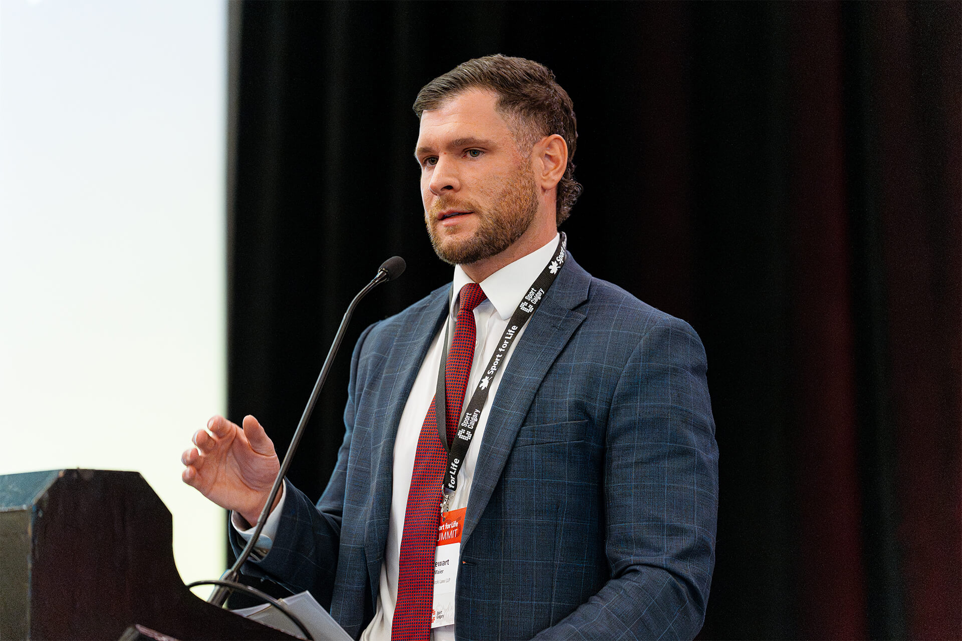 Sport policy speaker delivering address during Sport for Life Summit leadership event.