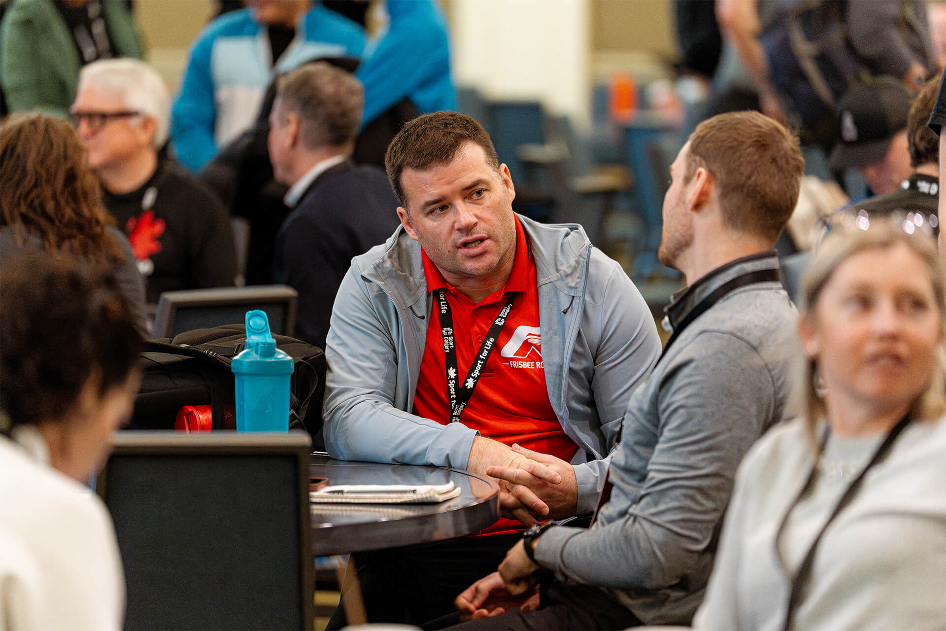 Sport professionals networking and discussing community sport development during Summit roundtable session.