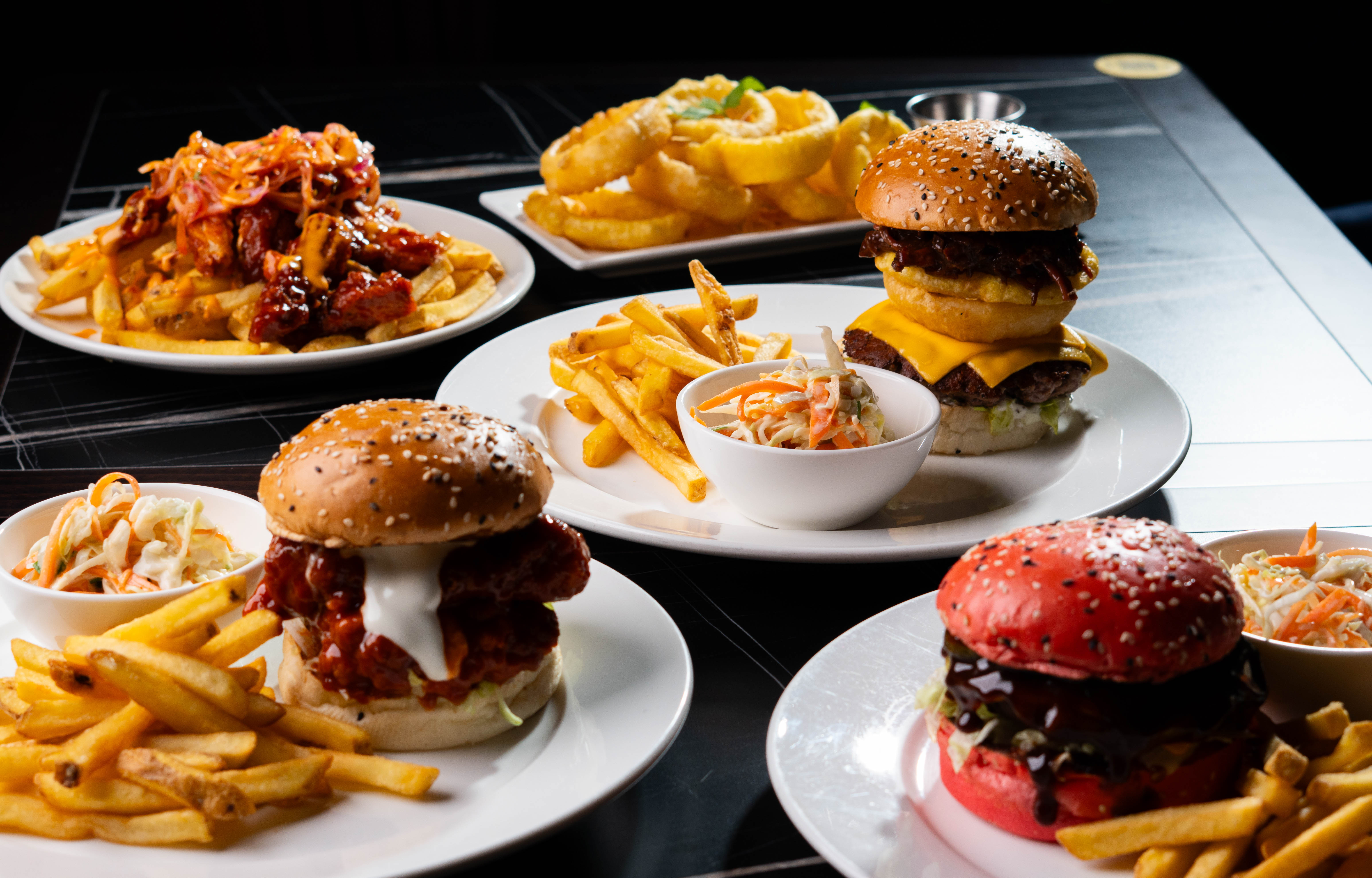 Guests gathered around a vibrant, creatively designed mini-golf course hole - Swingers crazy golf