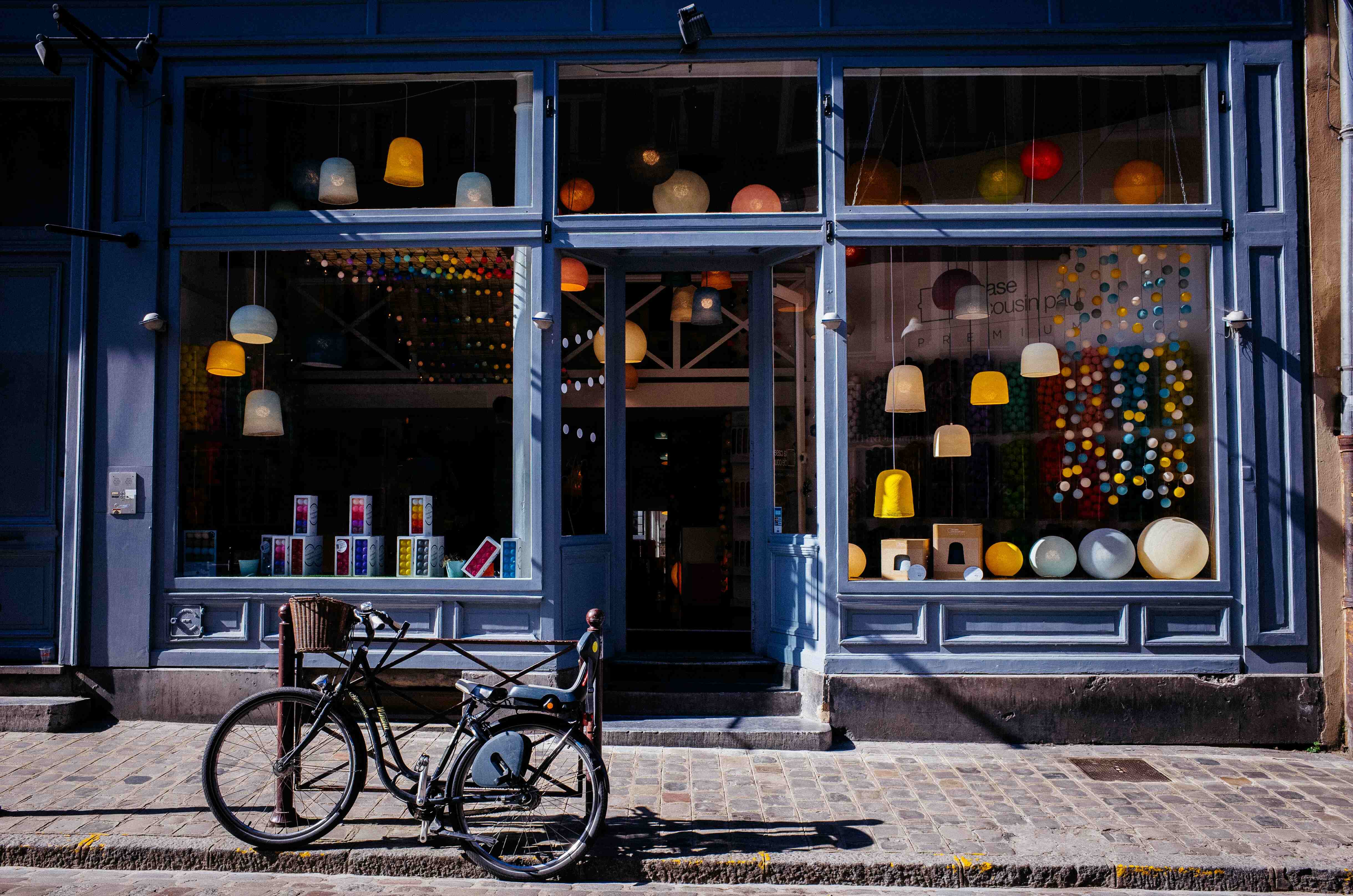 parked bicycle outside of a blue shop