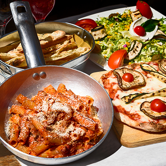 a table of pasta and pizza