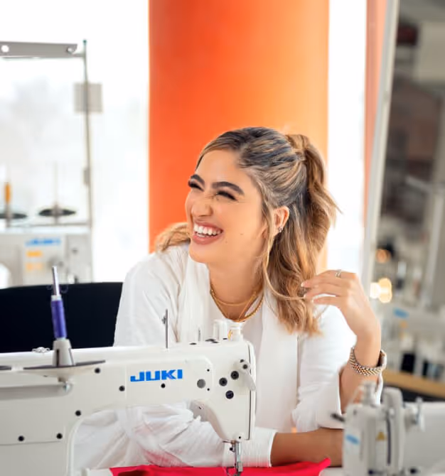 woman smiling while working at Dubai Institute of Design and Innovation