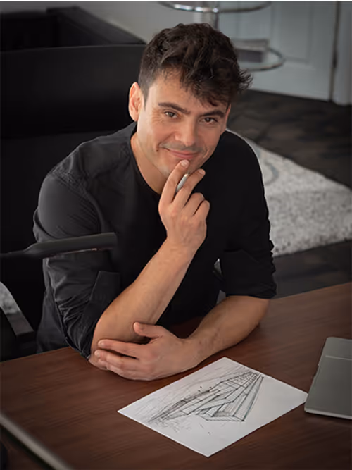 Thoughtful professional sitting at desk with graph and laptop