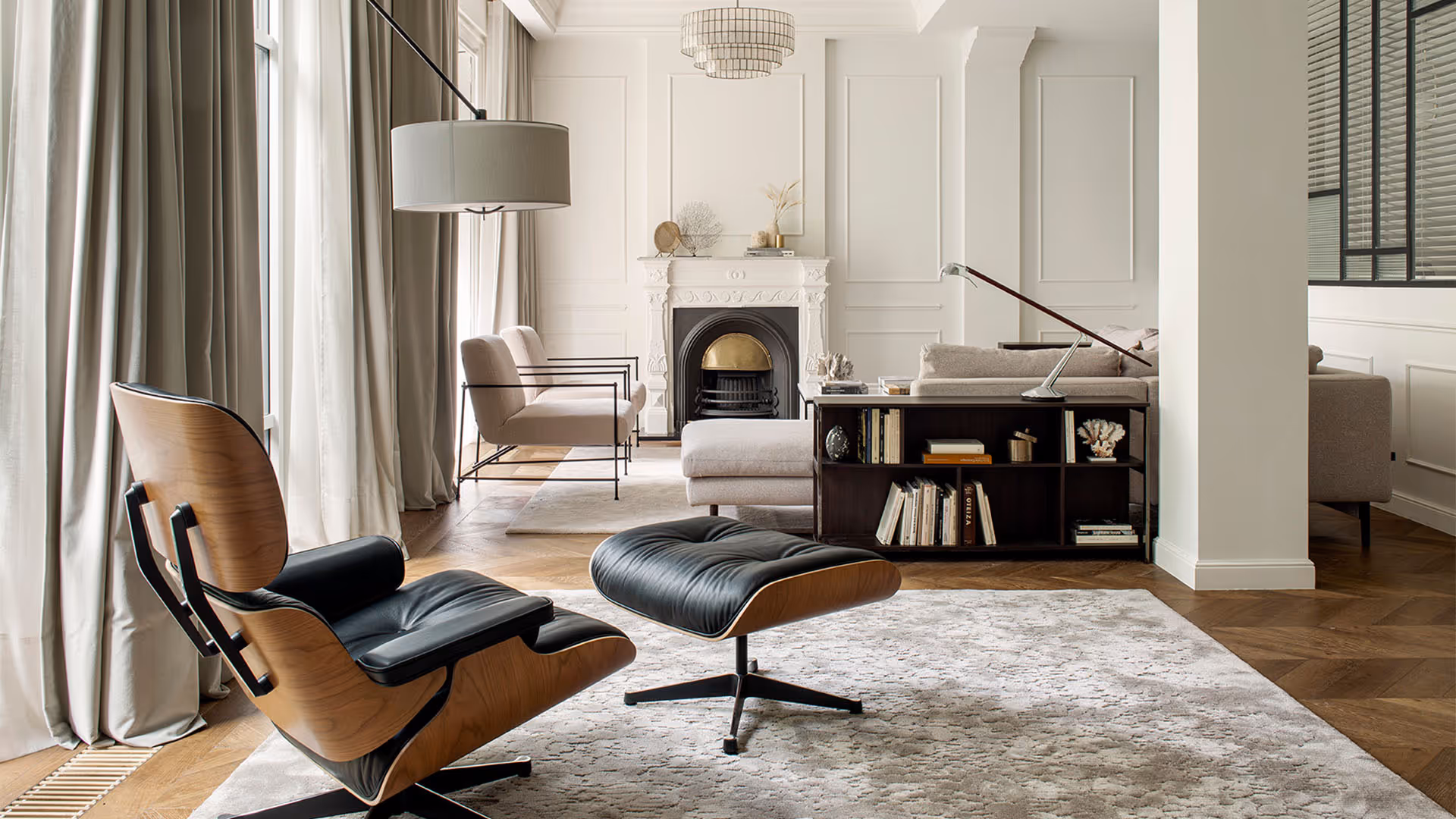 Elegant living room with designer chair, fireplace, and neutral color palette