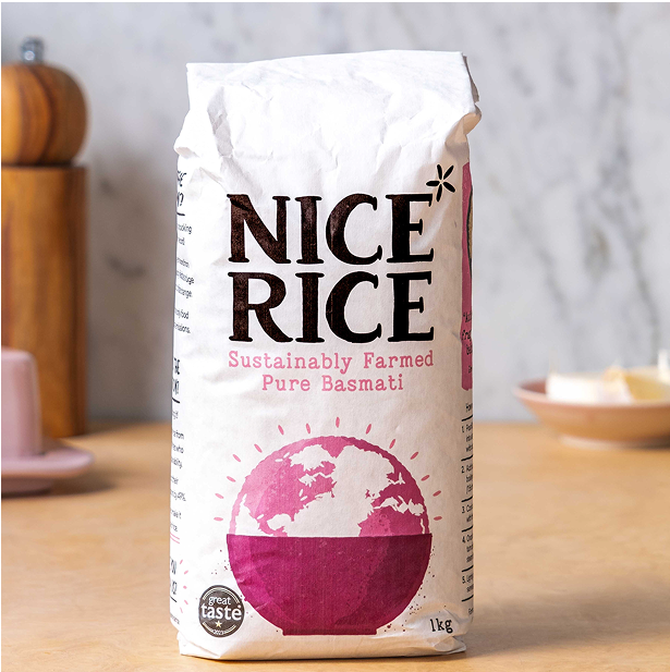A package of Nice Rice standing on a kitchen counter with a pepper grinder and salt pig in the background.
