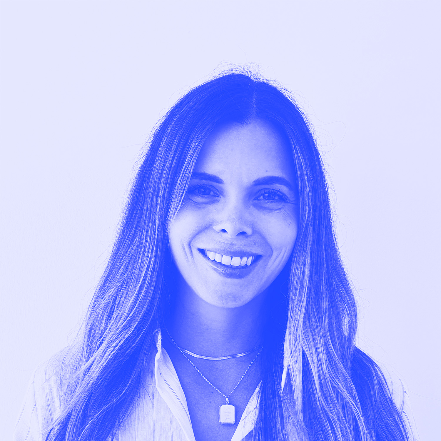 An image of a woman smiling with long blonde hair and necklaces. The image has a blue filter on it. 