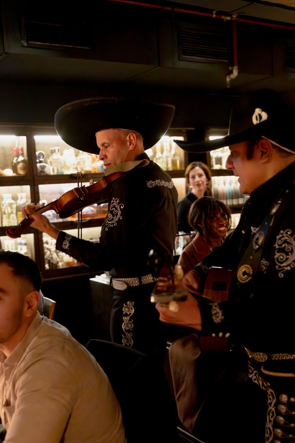 Guests seated at the bar at Esteban, Sydney, watching live mariachi
