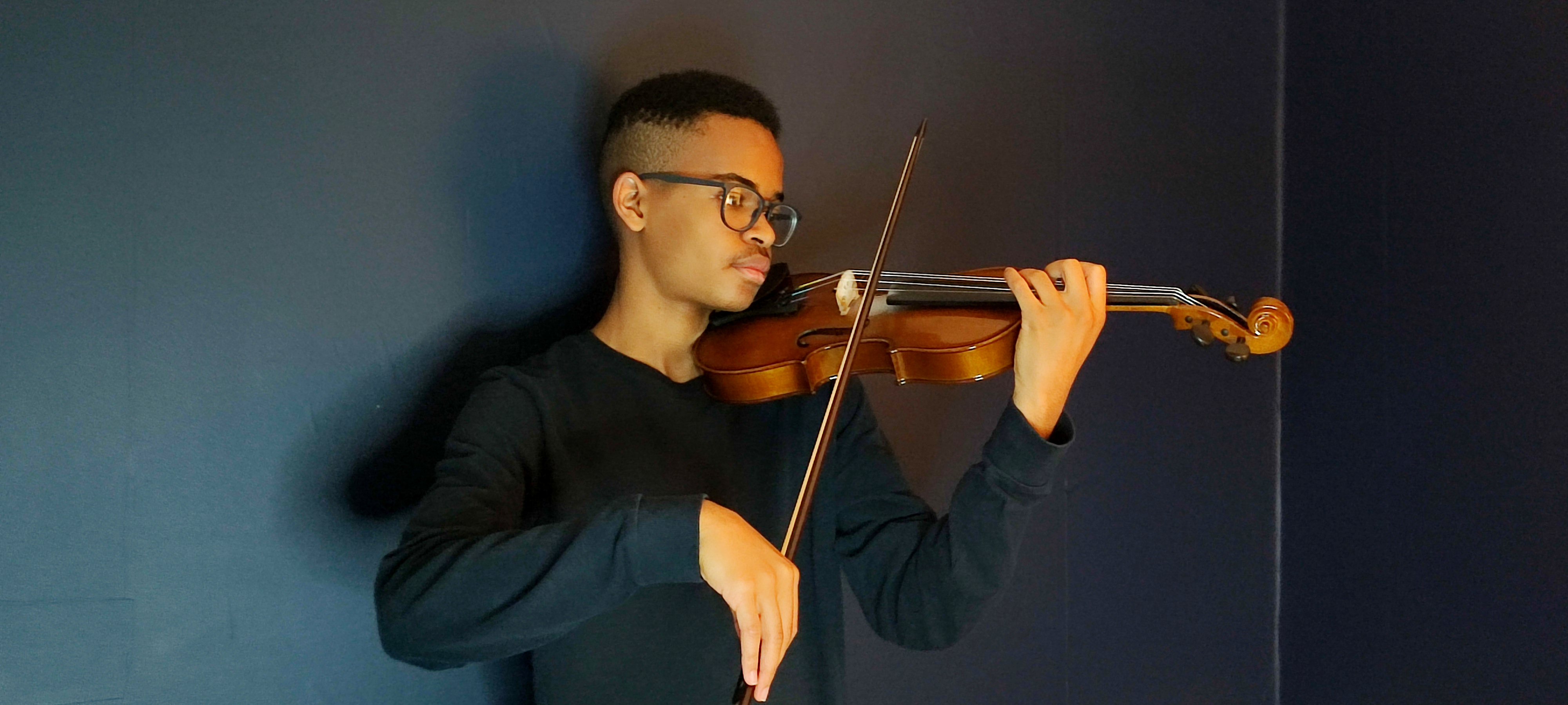 Elijah Mbale practising the violin