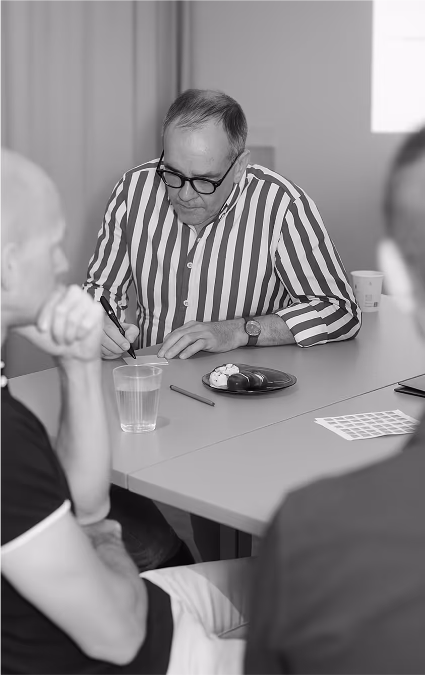 A man writing on a piece of paper