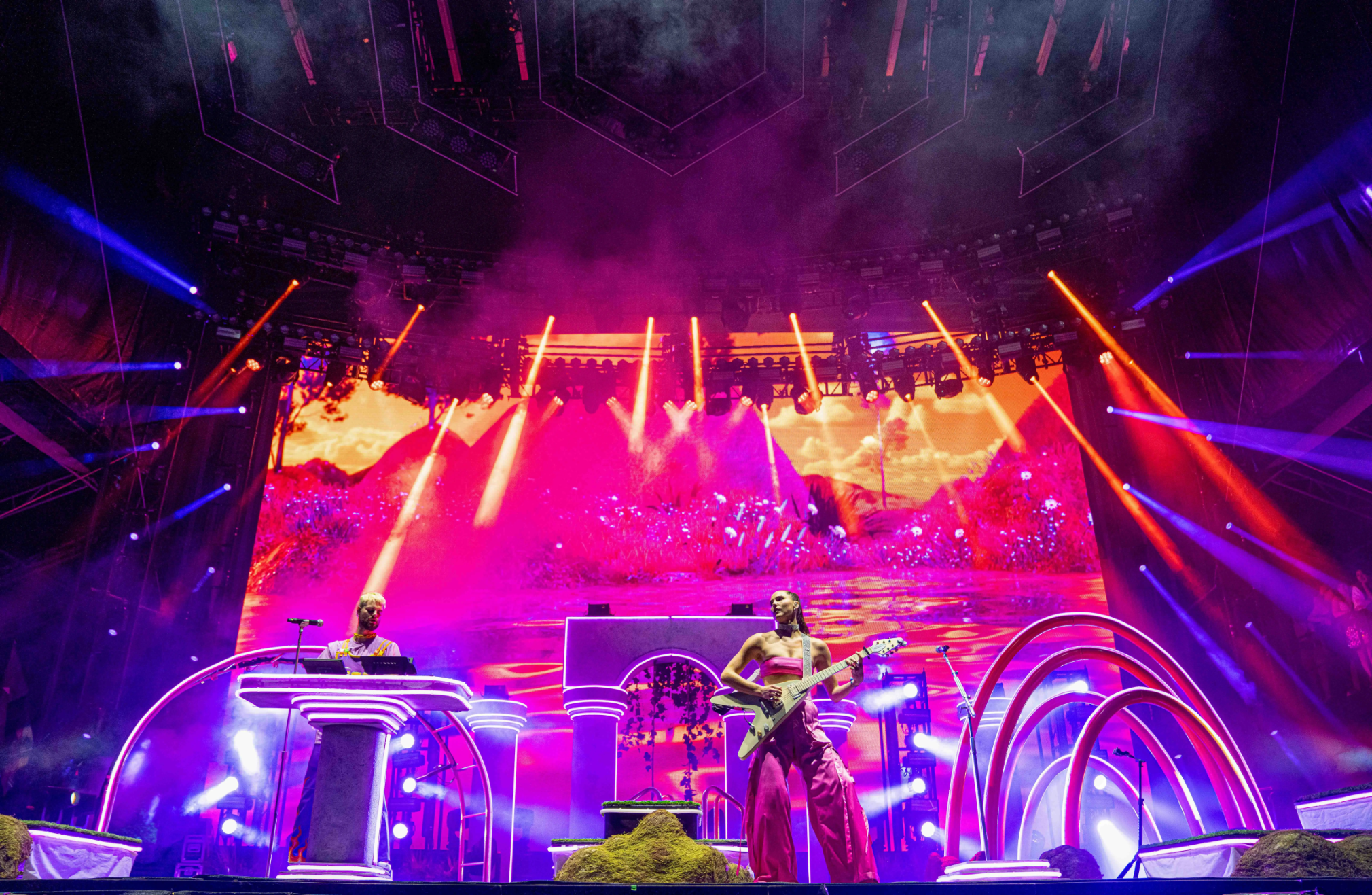 Sofi Tukker surrounded by Bob's Dance Shop dancers in front of the stage set.