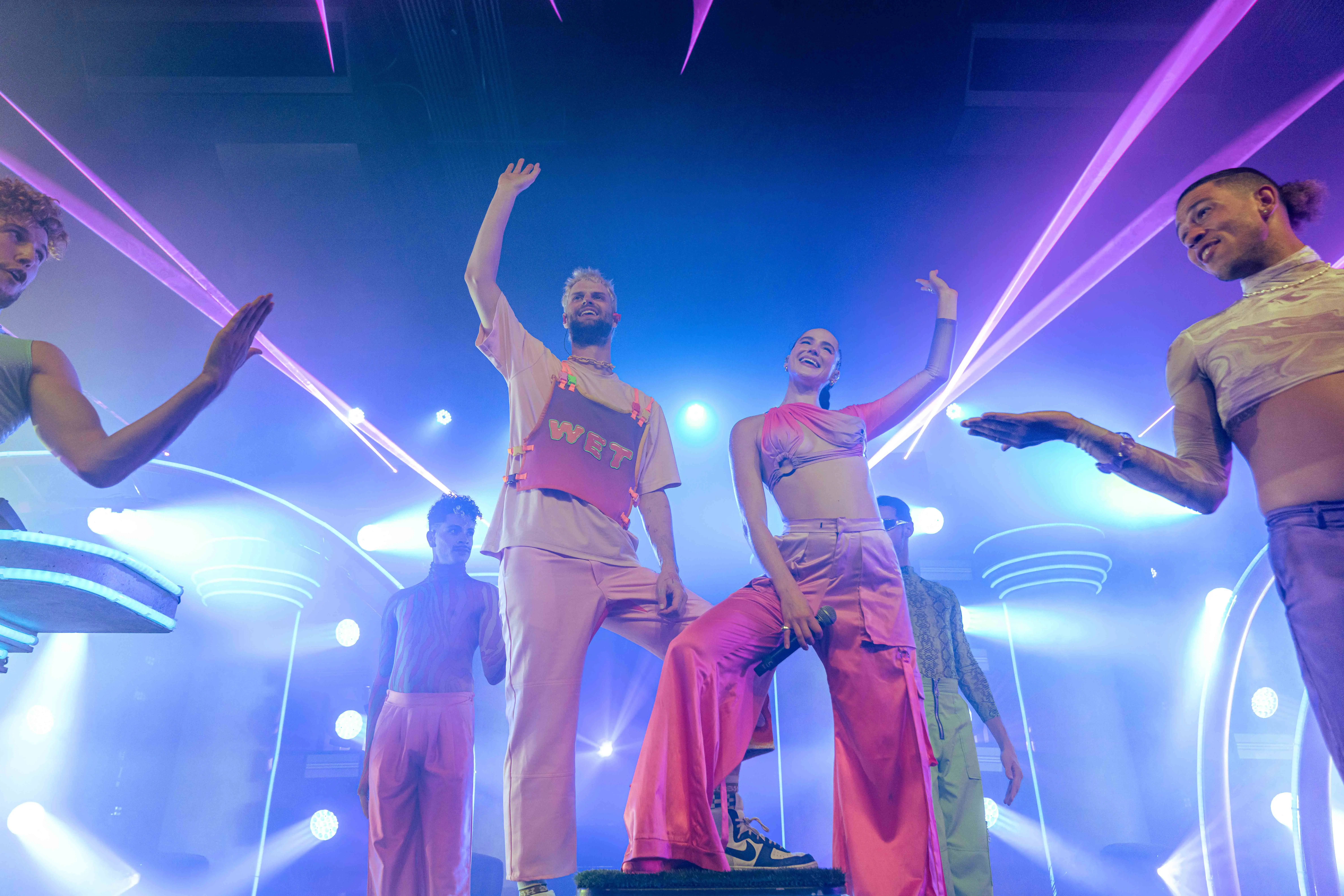 Sofi Tukker surrounded by Bob's Dance Shop dancers in front of the stage set.