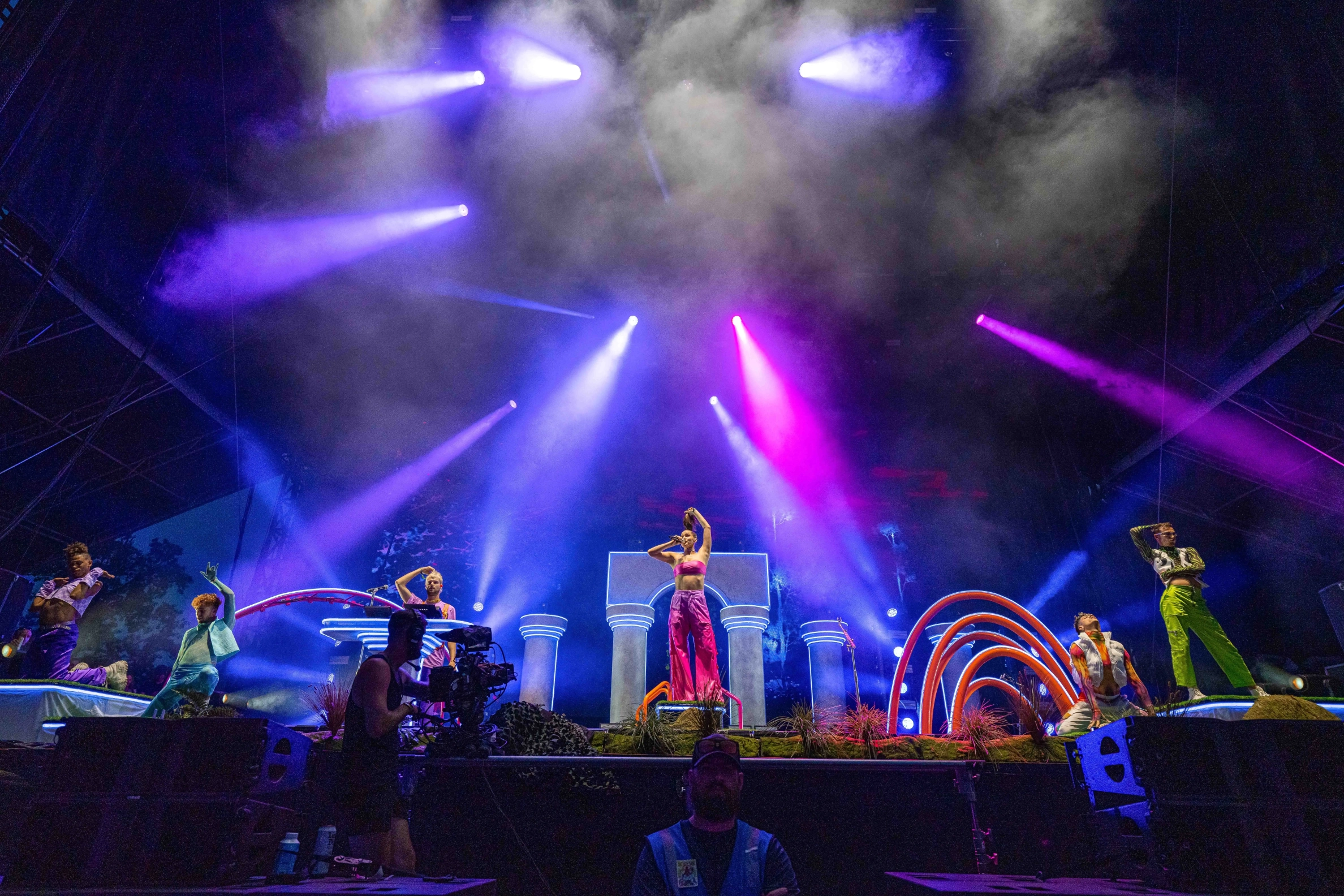 Sofi Tukker surrounded by Bob's Dance Shop dancers in front of the stage set.