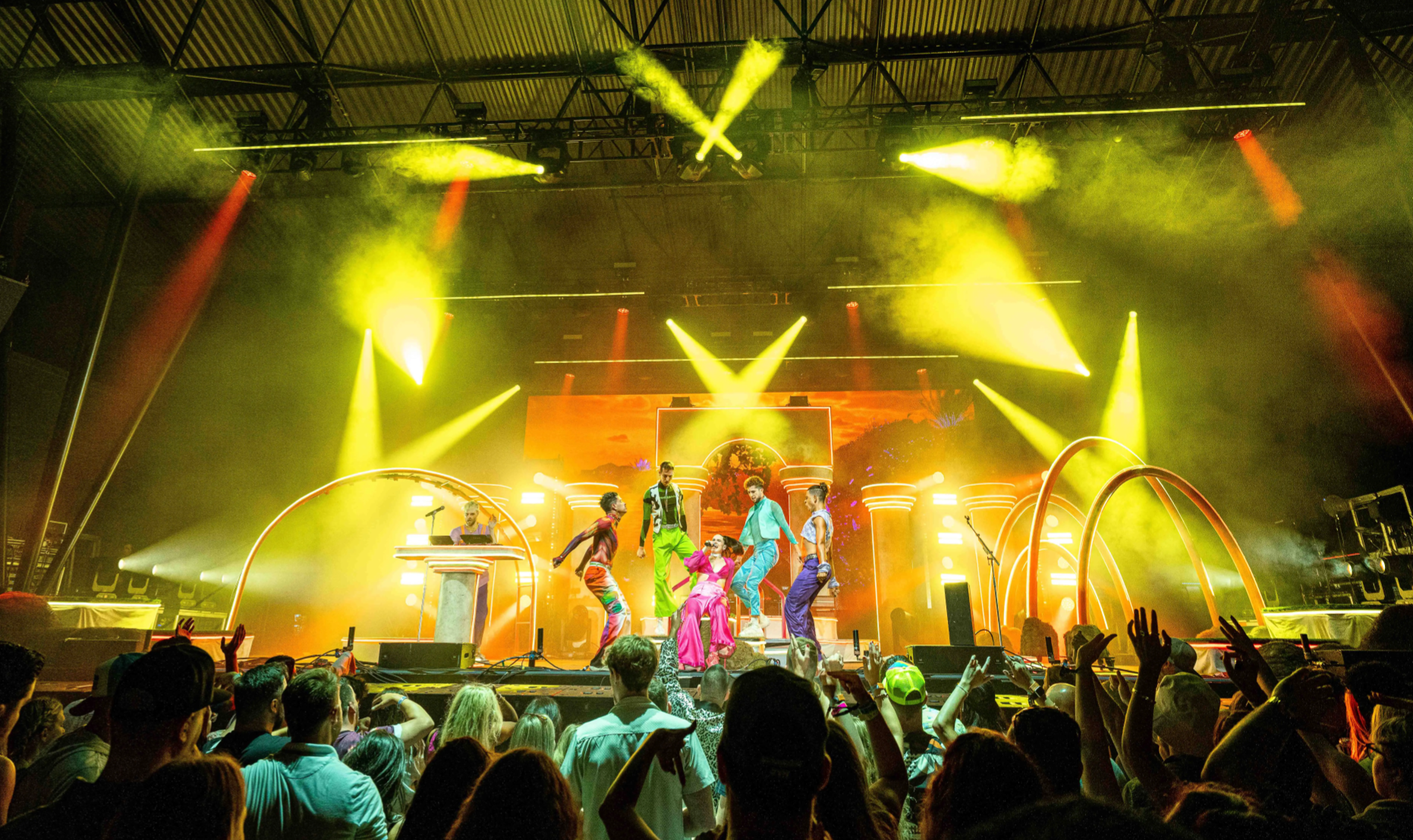 Sofi Tukker surrounded by Bob's Dance Shop dancers in front of the stage set.
