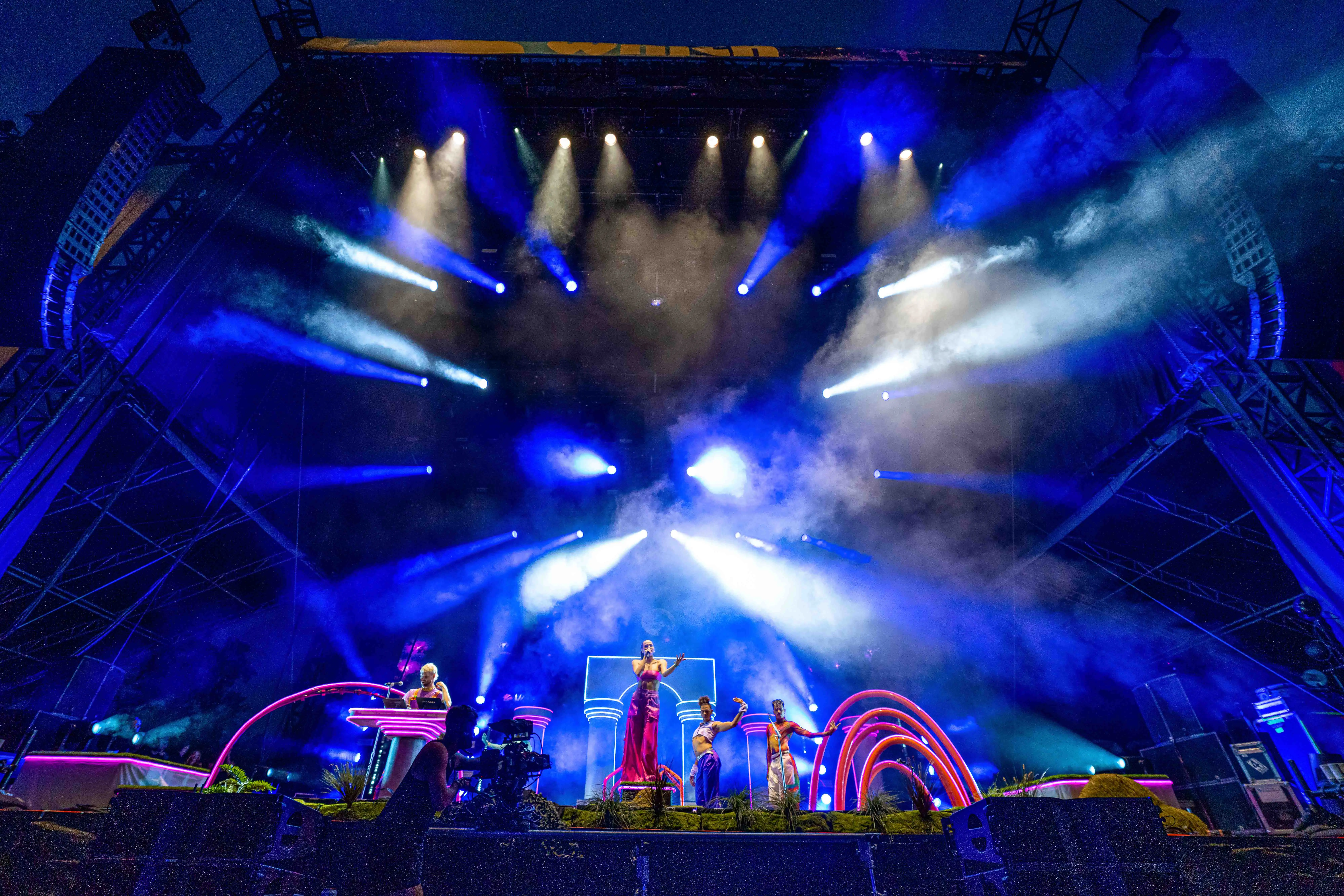 Sofi Tukker surrounded by Bob's Dance Shop dancers in front of the stage set.